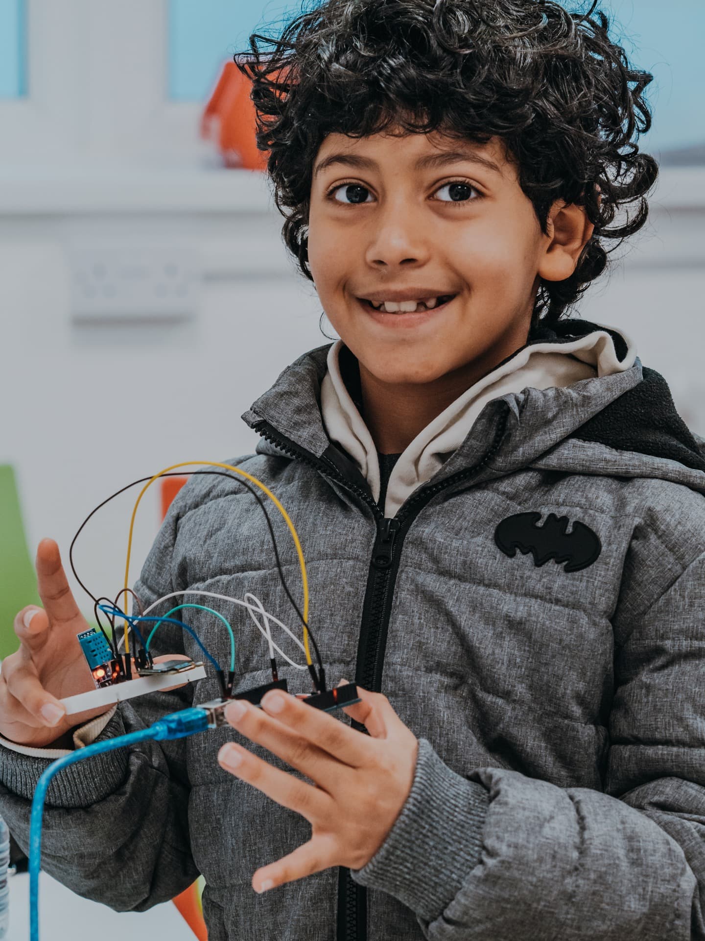 Student proudly showing off completed Arduino breadboard project