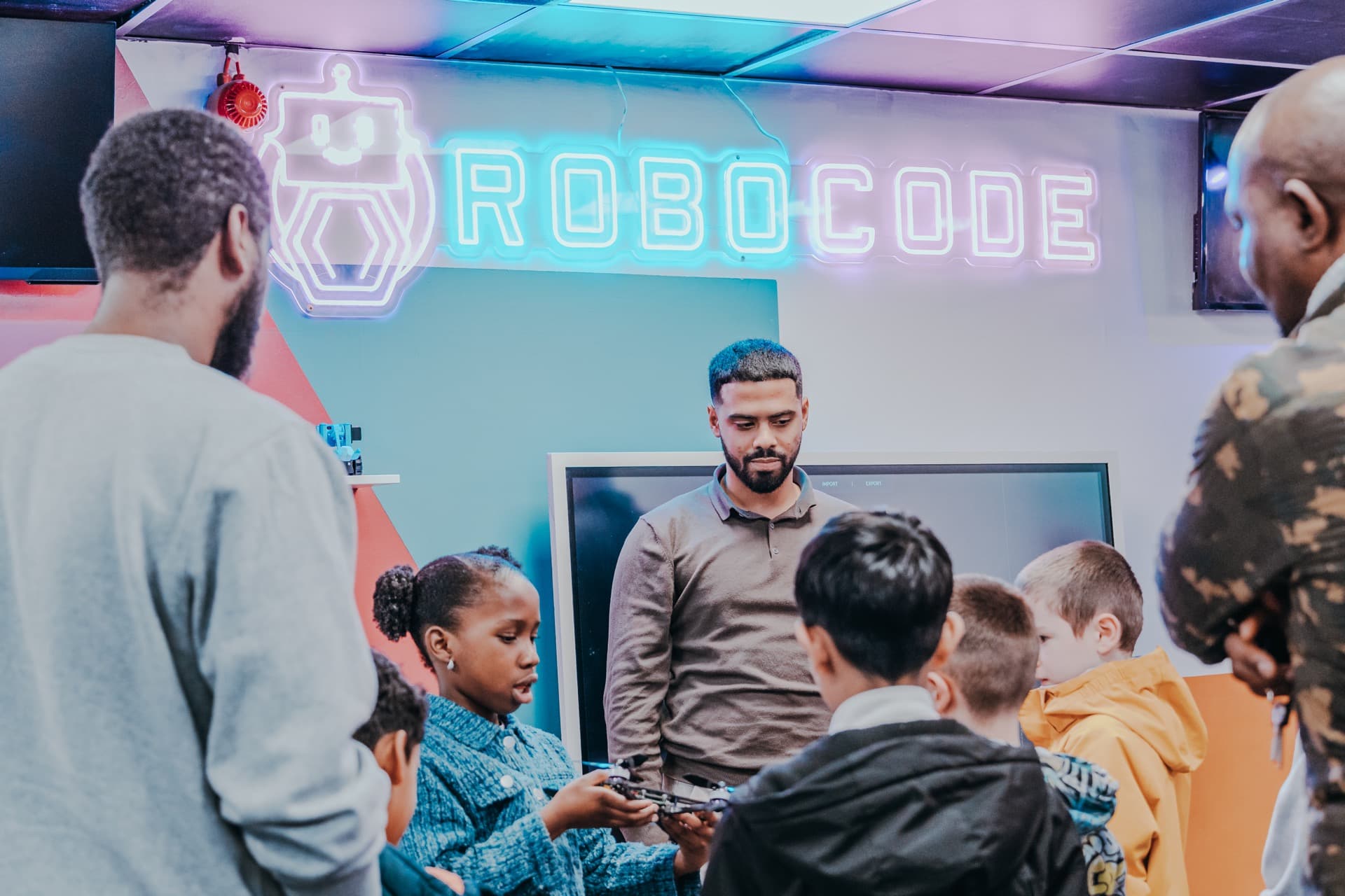 Teacher demonstrating drone technology to students at Robocode camp